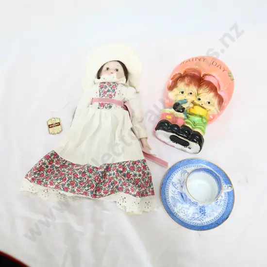 Assorted toys   Doll, money box, cup and saucers